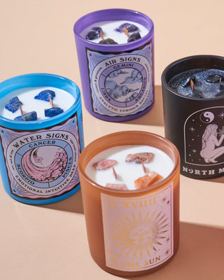 Four North Muse candles representing zodiac and celestial themes: Water Signs, Air Signs, The Sun, and a black celestial design.