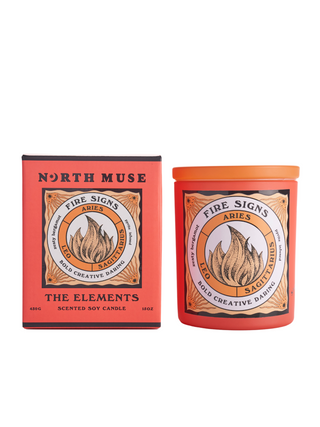 North Muse Fire Signs candle in an orange jar with matching box, featuring zodiac signs Aries, Leo, and Sagittarius.