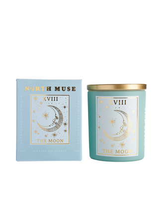 North Muse 'The Moon' candle with matching box, featuring a celestial crescent moon design in gold, both items displayed on a white background.